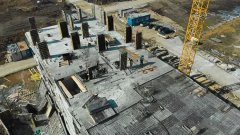 Aerial view of manual workers at construction site with a crane on background Stock Footage 144285691