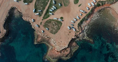 Aerial view of many camper vans on a parking lot. Aerial Footage of Scenic Sea Stock-Footage 129664376