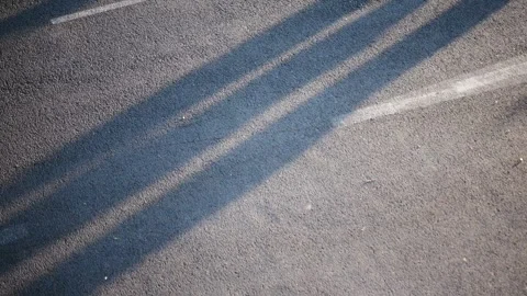 Aerial view of marathon runners casting long shadows on asphalt road Stock Footage 319428843