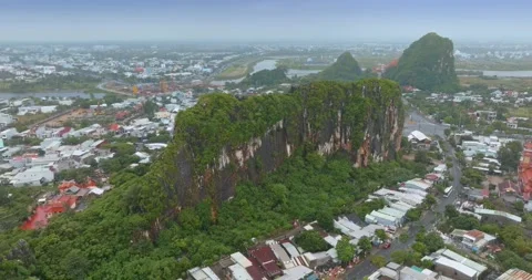Aerial view of Marble Mountains, Da Nang, Vietnam with city backdrop Stock Footage 331761279