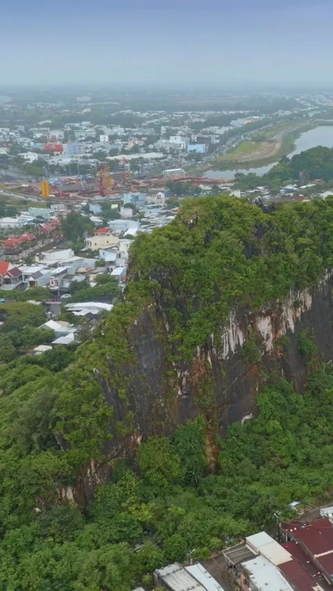 Aerial view of Marble Mountains, Da Nang, Vietnam with city backdrop Stock Footage 331766579