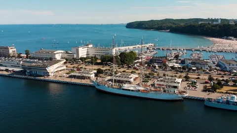 Aerial view of Marina Gdynia with ships and Ferris wheel in the background Stock Footage