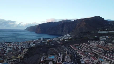 Aerial View of Masca Cliffs, Ocean, and Resorts in Tenerife at Sunrise Stock Footage 308220527