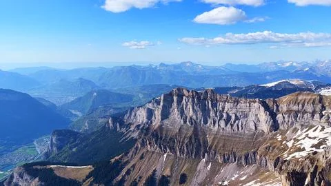 Aerial View of Massive Alpine Cliffs and Green Valley Stock Photos