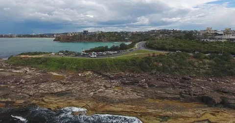 Aerial view on massive cliff rock with city on background Stock Footage 70826033