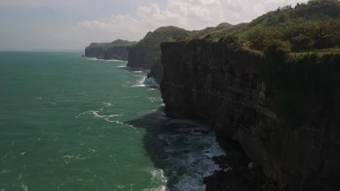 Aerial view of massive cliffs jutting down into the sea Stock Footage 293714550