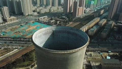 Aerial View of Massive Concrete Cooling Towers in Urban Industrial Zone Vidéo 334705394