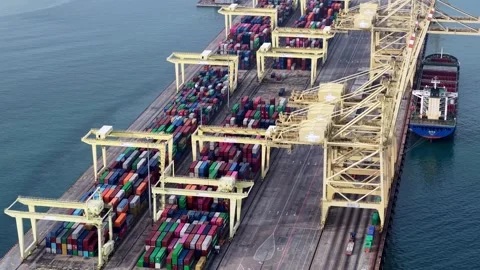 Aerial view of a massive container ship docked at a port Stock Footage 337982141