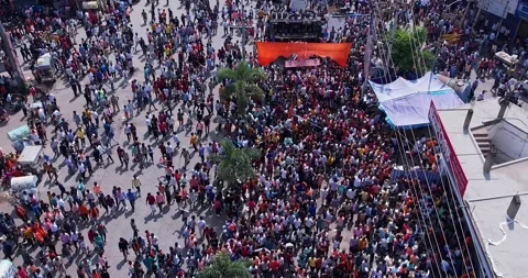 Aerial view of massive crowd dancing joyfully during immersion of lord Ganesh Stock Footage 340083926