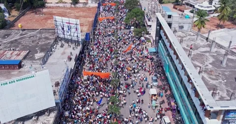 Aerial view of massive crowd dancing joyfully during immersion of lord Ganesh Stock Footage 340083961