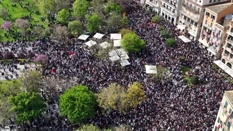 Aerial view of massive crowds gathering at Spianada Square for the historic Stock Footage 333819745