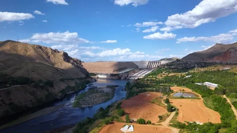 Aerial View of Massive Dam Under Partly Cloudy Sky Stock Footage 340236370