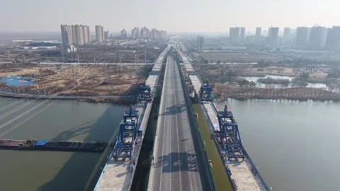 Aerial View of Massive Highway Bridge Under Construction Crossing River with Vídeos de archivo 326282371