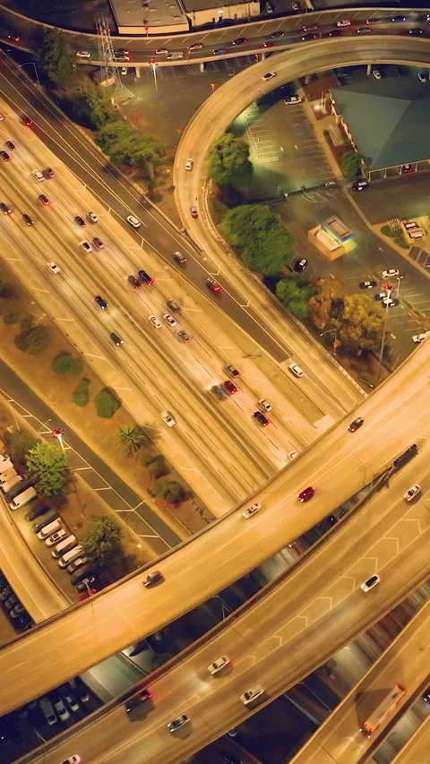 Aerial view of massive highway interchange at dusk. Illuminated streets Stock Footage 309980853