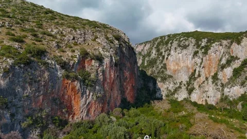 Aerial View of Massive Mountain Canyon With Vertical Rock Walls Stock Footage 330882540