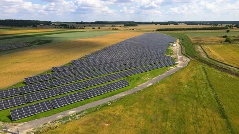 Aerial view, massive Solar panel farm on the field, alternative energy Vidéo 221044830