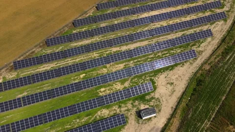 Aerial view, massive Solar panel farm on the field, alternative energy Vidéo 221076565