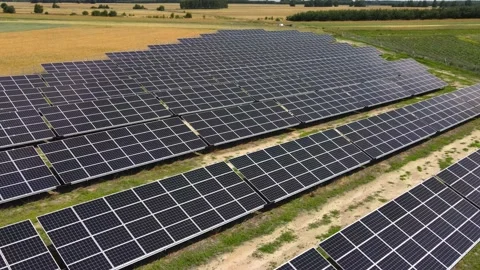 Aerial view, massive Solar panel farm on the field, alternative energy Vidéo 221079080