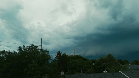 Aerial view of Massive storm clouds moving over a suburban neighborhood before Stock Footage 340449371
