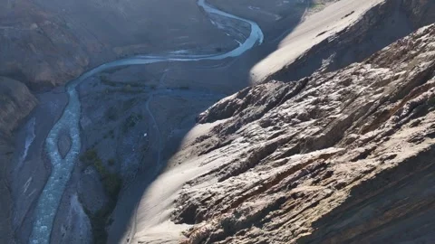 Aerial View of Massive Sunlit Rock Cliff Dropping into Deep River Gorge Video stock 333064926