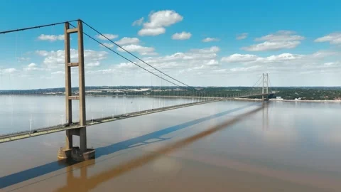 Aerial view of massive suspension bridge crossing wide river 스톡 동영상 343524009