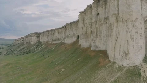 Aerial view of massive white cliffs and green slopes Stock Footage 333837475