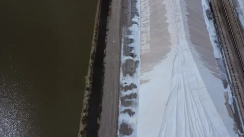 Aerial view of massive white salt heap beside industrial lagoon factory Stock Footage 337048765