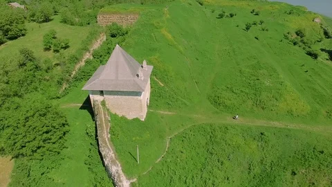 Aerial view of meadows. Stunning shot over lush green fields in the castle ruins Stock Footage 77444053