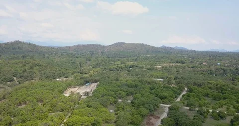 Aerial view of a mechanical digger in a forest starting a deforestation program Stock Footage 106660403