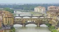 Aerial view of medieval arch bridge Vecchio across the Arno river in Florence HD Footage