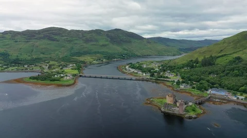 Aerial view of medieval Eilean Donan Castle on island - Scotland, UK, Europe Stock Footage 113958361