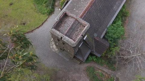 Aerial view of a medieval stone tower and building in the rain Stock Footage 341904351