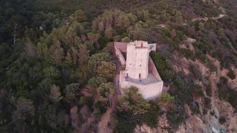 Aerial view of a Medieval tower overlooking a rocky sea coast Stock Footage 94601045