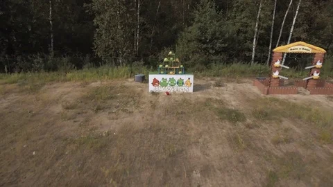 Aerial view men playing giant slingshot game knocking down plushies outside Stock Footage 72289261