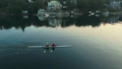 Aerial View Of Men Rowing In Two-Seater Boat In Halifax Bay During Summer Dawn Stock Footage 317996722