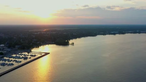 Aerial view of Menominee shore and marina at sunset Stock Footage