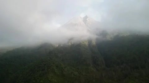 Aerial view of Merapi Volcano mountain covered by mist and fog in the morning Video stock 290988384