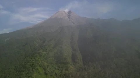 Aerial view of Merapi Volcano mountain covered by mist and fog in the morning Vídeos de archivo 290988897