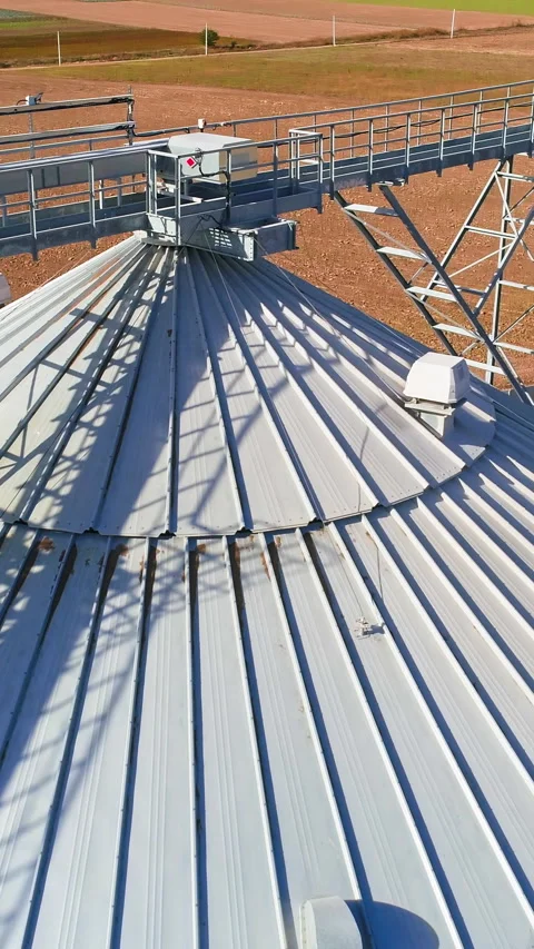 Aerial view. Metal grain elevator in agricultural zone.  Stock Footage 288994957