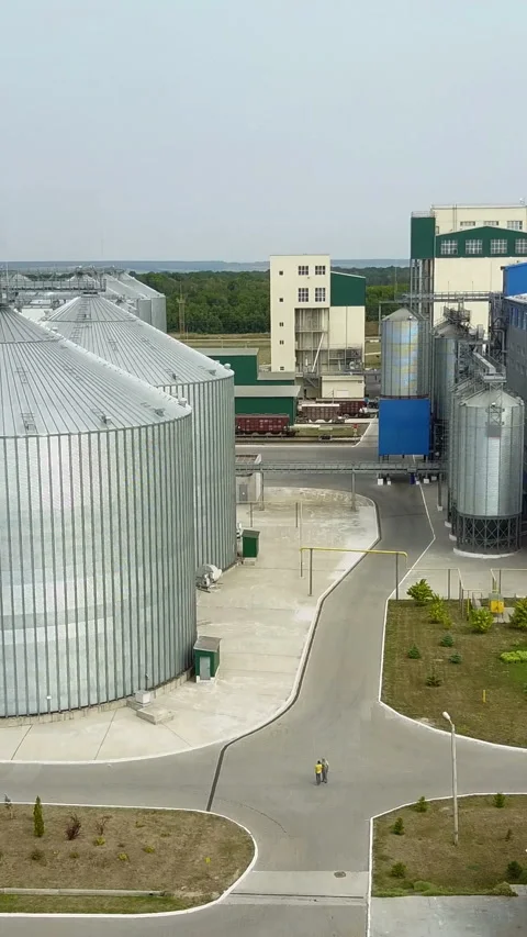 Aerial view. Metal grain elevator in agricultural zone Stock Footage 296734640