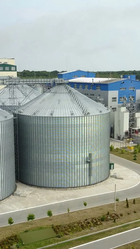 Aerial view of metal grain elevator in agricultural zone.  Stock Footage 296734663