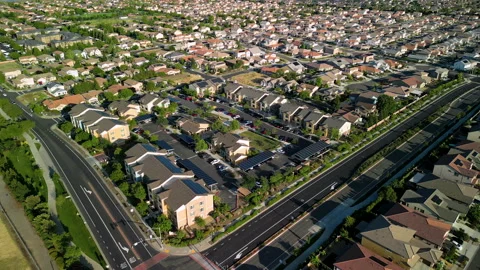 Aerial view of a middle class brand new residential houses neighborhood Stock Footage 274847494
