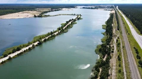 Aerial view mining quarry lakes highway train tracks Stock Photos