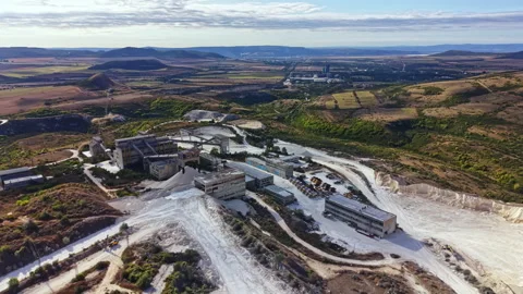 Aerial view of a mining site with buildings and machinery in a rural landscape Stock Footage 345456976