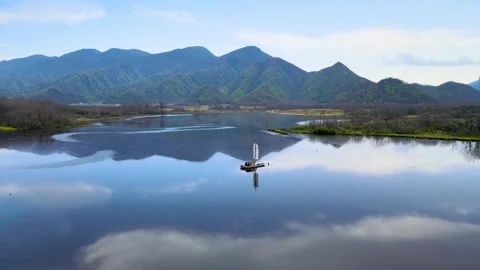 Aerial View of Mirror Lake Small Boat Distant Green Mountain in Shennongjia Video stock 337938714
