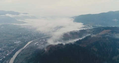 Aerial view: Misty forest, Flying through the clouds in Transcarpathian city 動画素材 95876852