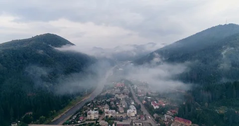 Aerial view: Misty forest, Flying through the clouds in Transcarpathian city Stock-Footage 95876910