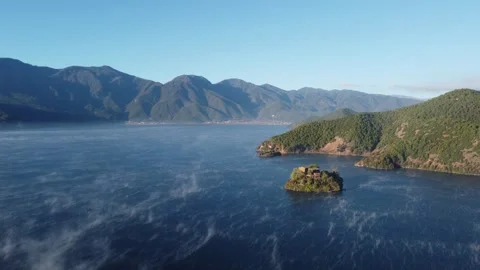 Aerial View of Misty Lake Surface in Lugu Lake Yunnan China Stock Footage 336896373