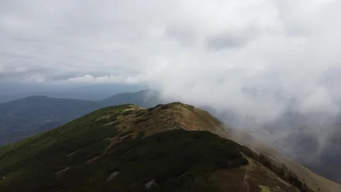 Aerial view of misty mountain ridge covered with clouds in summer Stock Footage 337047816