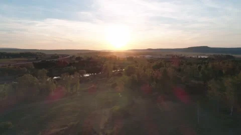 Aerial view of a misty river surrounded with green trees at foggy sunrise. Calm Stock Footage 196229335